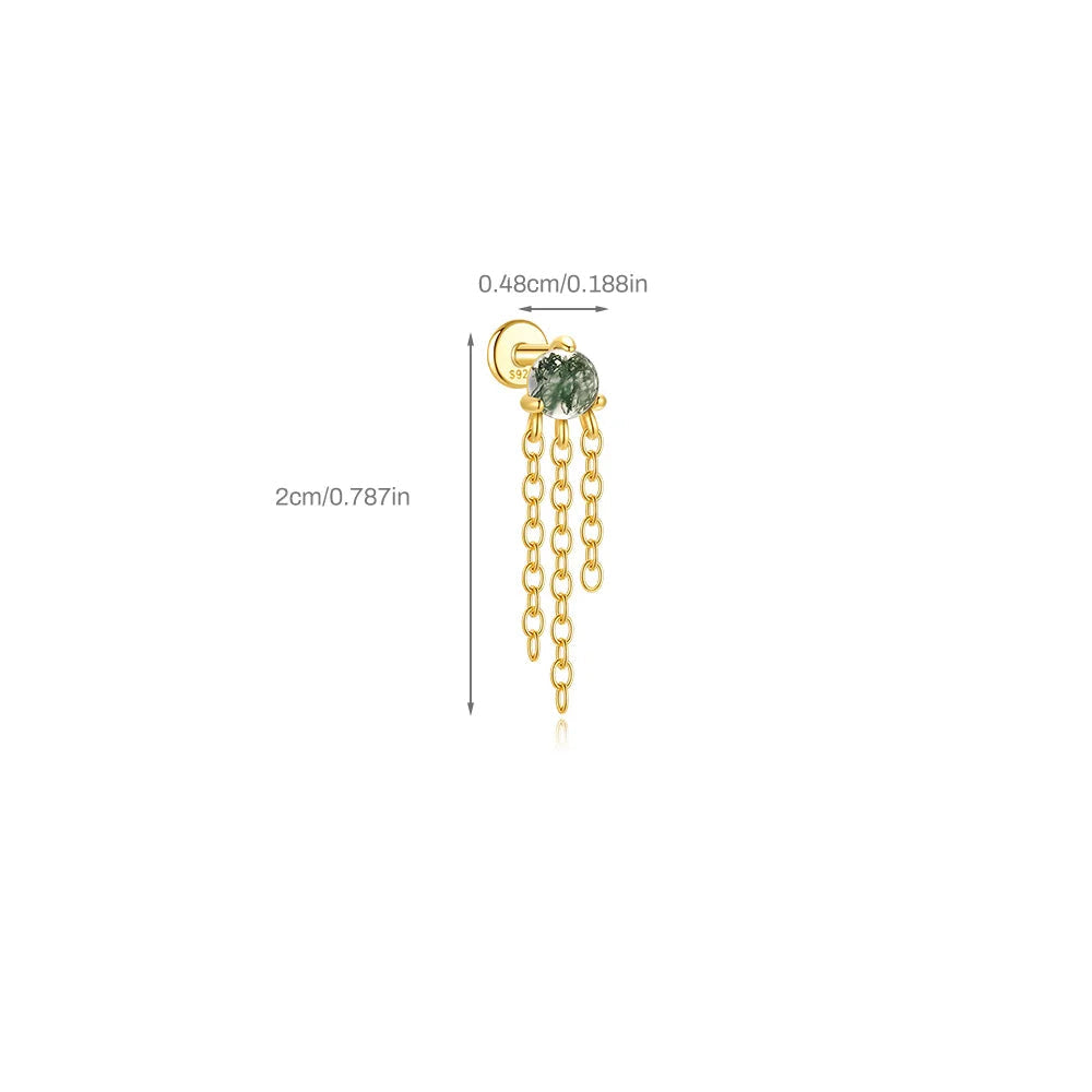 Gold earring with green gemstone and chain on a white background
