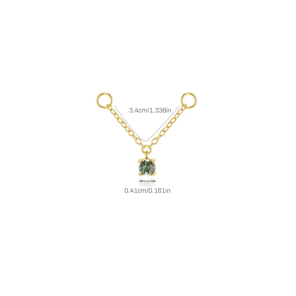 Gold necklace with a green gemstone pendant on a white background
